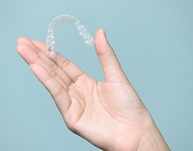 Patient holding clear aligners