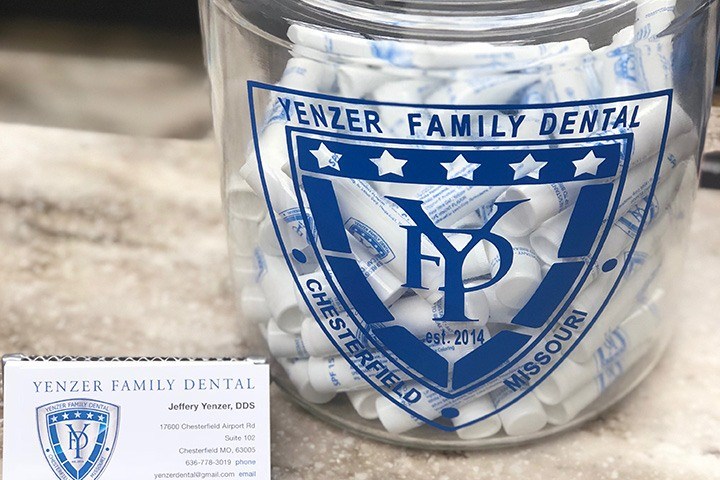 Yenzer Family Dental of Chesterfield logo on jar with lip balm