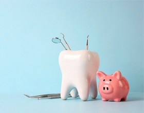 a tooth next to a piggy bank