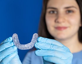 Person holding a custom-made nightguard