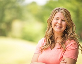 Woman smiling after denture tooth replacement