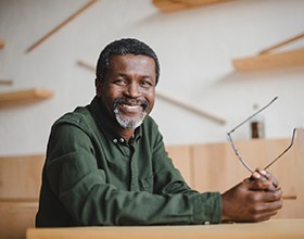 a mature man smiling with dentures in Chesterfield