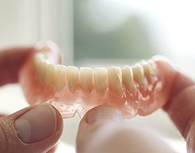 Holding dentures for the lower arch