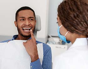 Man with a toothache in Chesterfield visiting their dentist