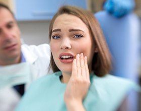 Relaxed woman smiling in dental chair after tooth extraction