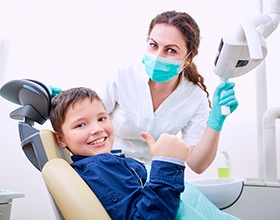 a child and his dentist smiling 