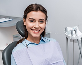 a patient smiling while visiting her dentist
