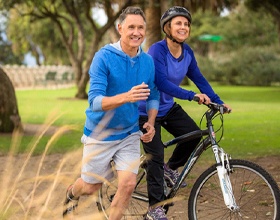 Couple wearing blue biking and running outside