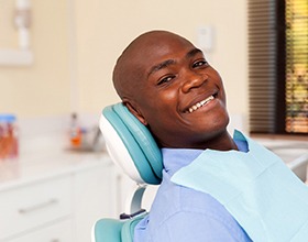 man smiles after getting dental implants in Chesterfield 