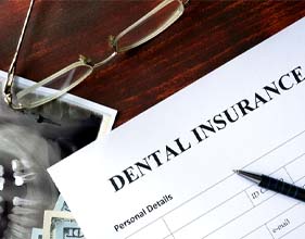 Dental insurance form on desk with X-ray