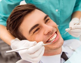 Smiling man in dental chair after iTero scan