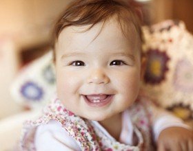 Smiling baby girl after first children's dentistry visit