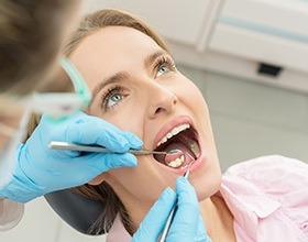 Woman receiving oral cancer screening