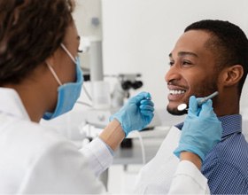 a patient smiling while getting his teeth checked