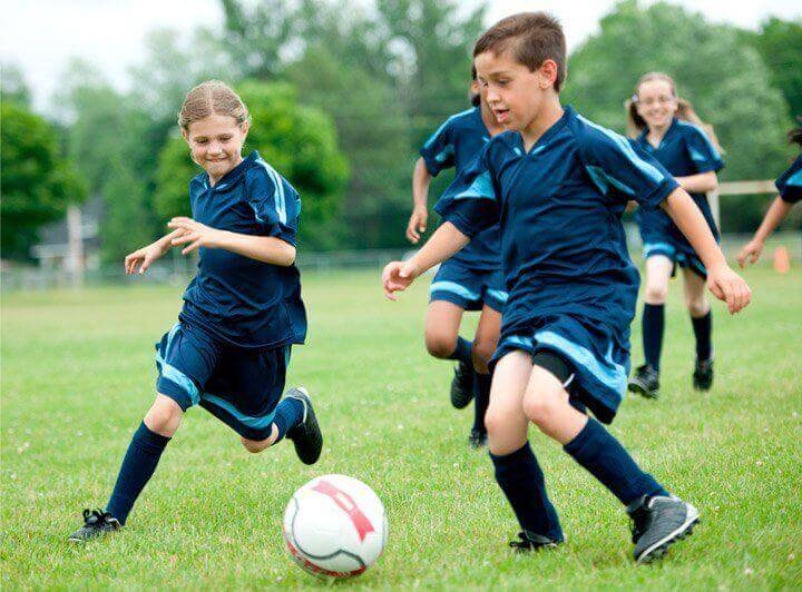 Group of children playing soccer