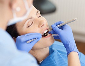 Relaxed woman receiving dental care under sedation dentistry