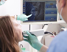 Woman and dentist looking at intraoral photos