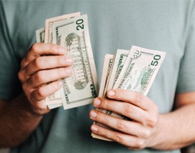 Close up of man’s hands counting cash