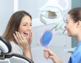 woman admiring her new porcelain veneers in Chesterfield