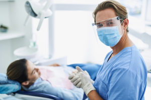 A dentist in Chesterfield watches a patient from a safe distance.