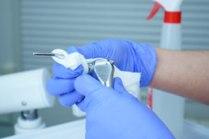 Dentist in Chesterfield cleans a dirty surface.