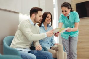 dentist in Chesterfield showing two patients how to maximize dental insurance benefits