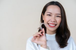 patient holding invisalign tray