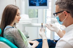 dentist showing patient a diagram of dental implants in chesterfield