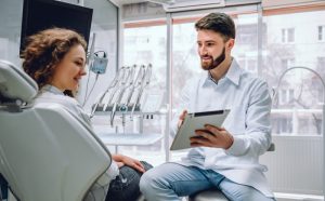 dentist explaining facts about root canal therapy to a patient 